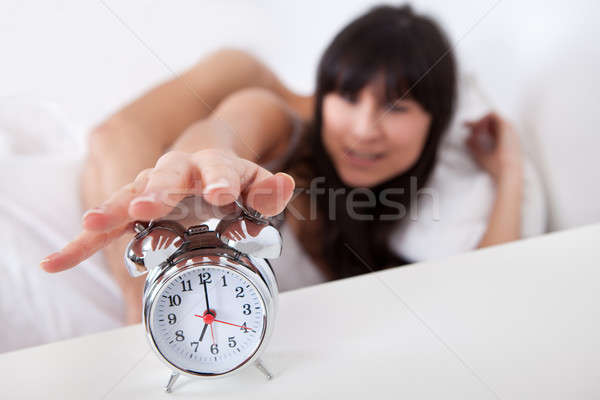 Lovely young couple and alarm clock Stock photo © AndreyPopov