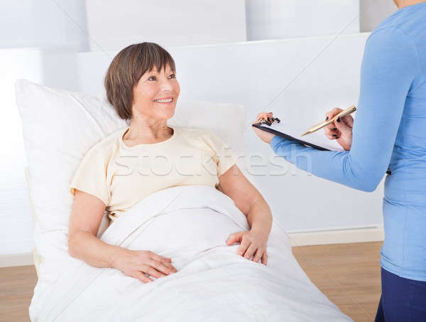 Caretaker With Clipboard Attending Senior Woman Stock photo © AndreyPopov