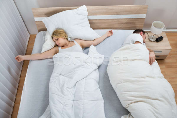 Portrait Of Couple Lying In Bed Stock photo © AndreyPopov