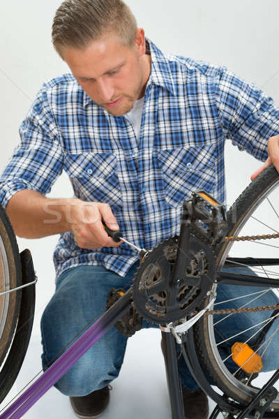 Young Man Fixing Bicycle Stock photo © AndreyPopov