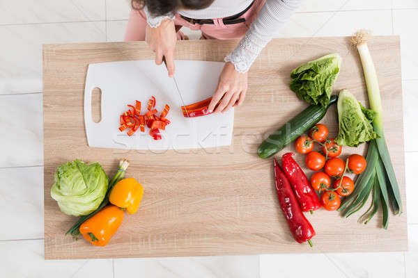 Stock photo: Woman Chopping Vegetable On Countertop
