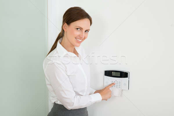 Businesswoman Enter Code In Security System Stock photo © AndreyPopov