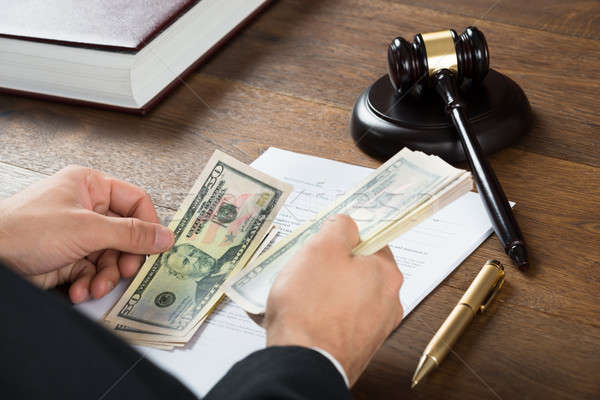 Corrupt Judge Counting Money At Desk Stock photo © AndreyPopov