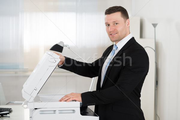 Businessman Using Photocopy Machine In Office Stock photo © AndreyPopov