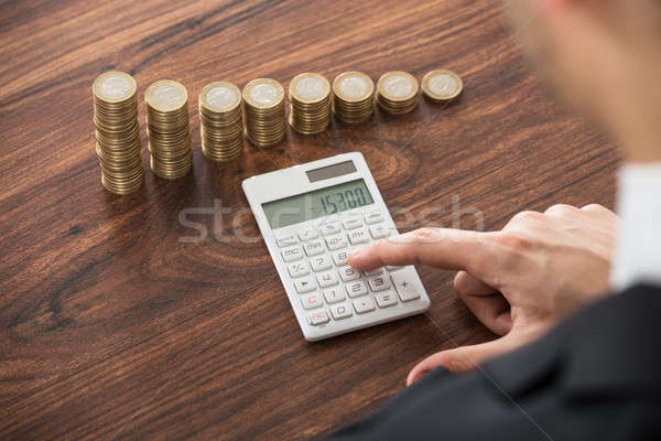 Stock photo: Businessman Calculating With Calculator