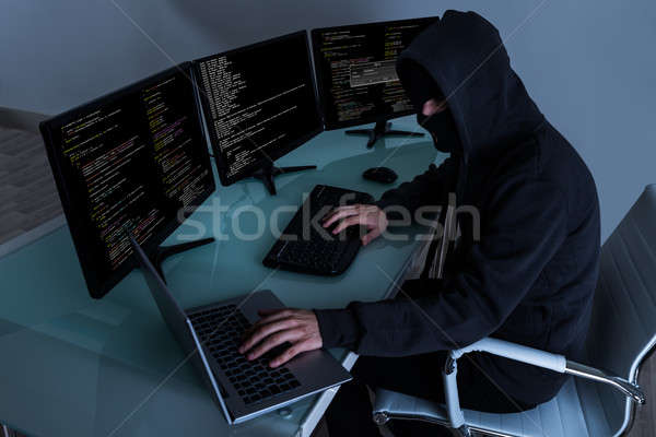 Hacker Stealing Data On Multiple Computers Stock photo © AndreyPopov