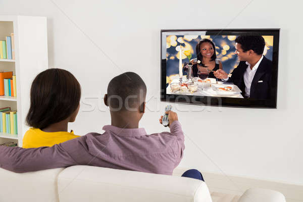 快樂 情侶 看電視 非洲的 家 房子 商業照片 © AndreyPopov