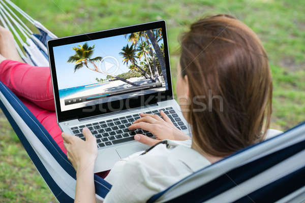 Woman Watching Video On Laptop Stock photo © AndreyPopov