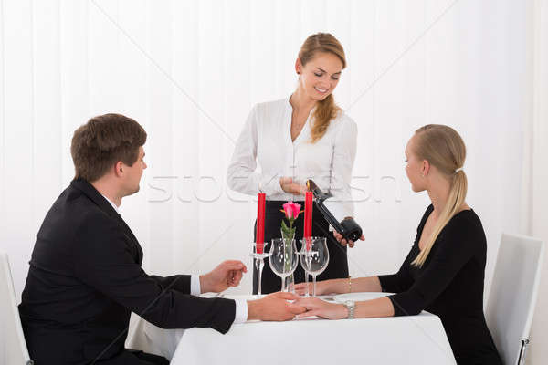 Waitress Suggesting Bottle Of Wine To Couple Stock photo © AndreyPopov