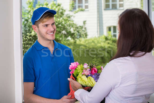 Woman Received Bouquet From Delivery Man Stock photo © AndreyPopov