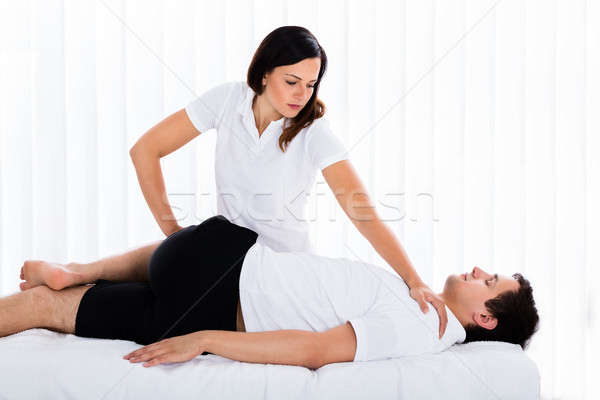 Female Therapist Massaging Man's Leg Stock photo © AndreyPopov