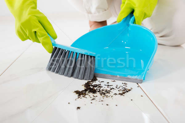 Stock photo: Person Sweeping Floor With Broom And Dustpan