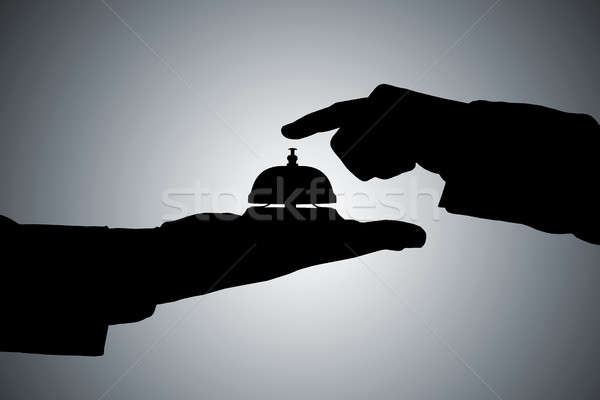Silhouette Of A Person's Hand Ringing Service Bell Stock photo © AndreyPopov