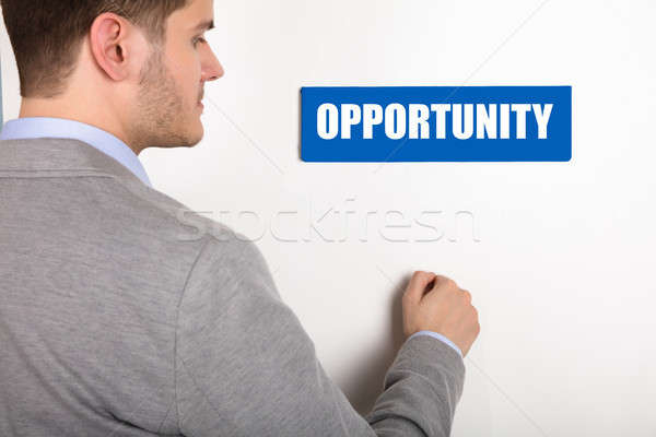 Businessman Knocking Door With Opportunity Text Stock photo © AndreyPopov