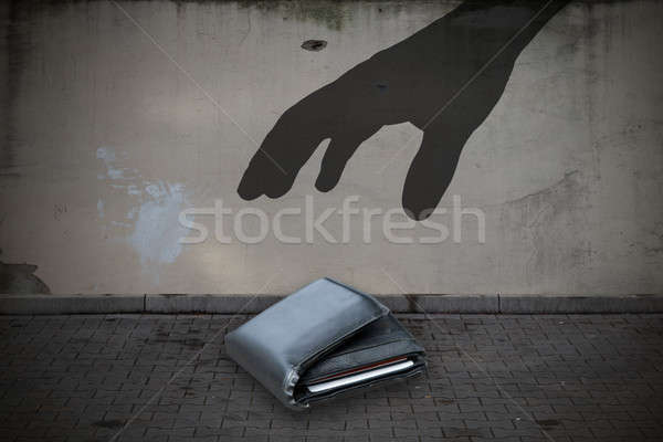 Close-up Of Hand Picking Up Wallet On Street Stock photo © AndreyPopov