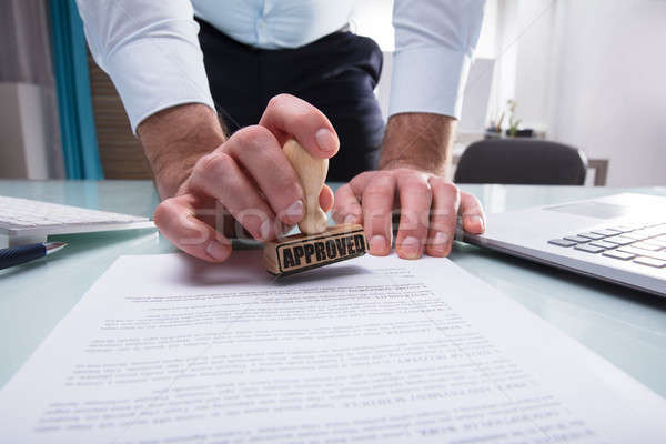 Businessman Stamping Approved On Document Stock photo © AndreyPopov