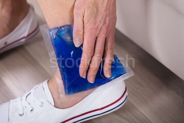 Person Applying Ice Bag On Ankle Stock photo © AndreyPopov