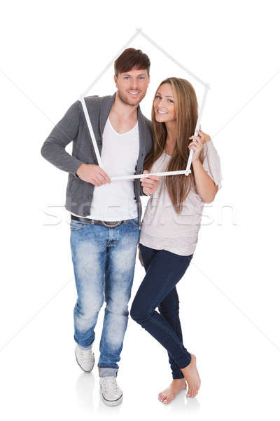 Smiling couple posing inside a frame Stock photo © AndreyPopov
