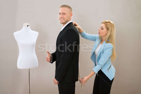 Feminino alfaiate medição terno homem Foto stock © AndreyPopov