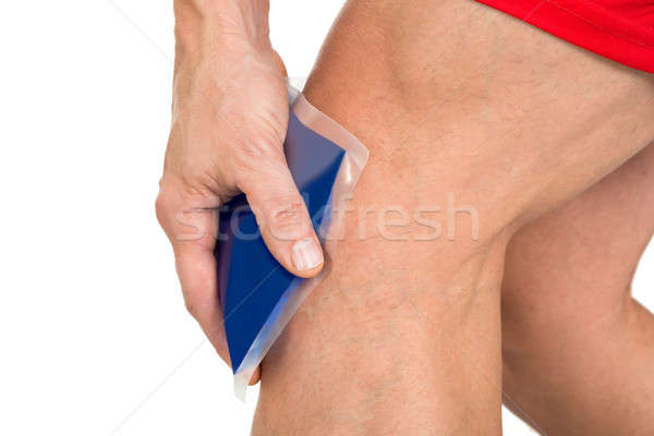 Hand Holding Ice Gel Pack On Knee Stock photo © AndreyPopov