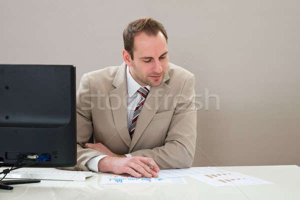 Businessman Analyzing Graph In Office Stock photo © AndreyPopov