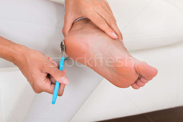 Close-up Of Woman Filing Foot Stock photo © AndreyPopov