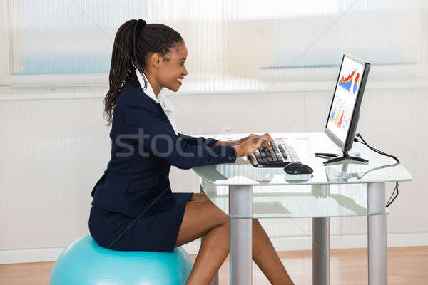 Businesswoman Sitting On Fitness Ball Using Computer Stock photo © AndreyPopov