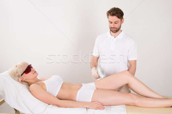 Young Woman Receiving Laser Epilation Treatment At Spa Stock photo © AndreyPopov