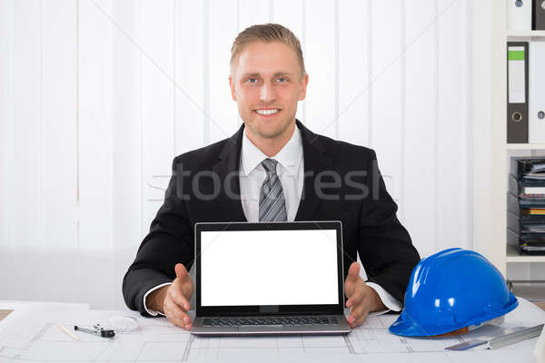 Architect Showing His Laptop Over Blue Print Stock photo © AndreyPopov