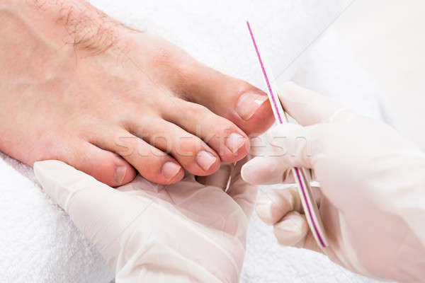 Beautician Hand Filling Person's Nail Stock photo © AndreyPopov