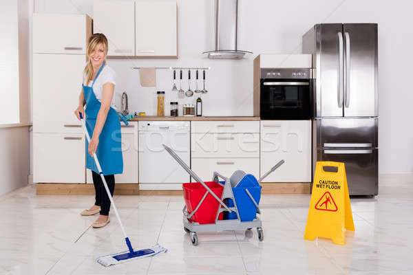 Woman Cleaning Kitchen Floor With Mop Stock photo © AndreyPopov