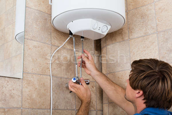 Man Installing Electric Boiler Stock photo © AndreyPopov