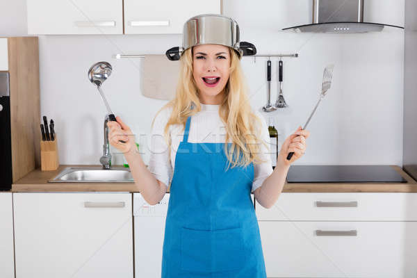 Woman Wearing Cooking Pan Holding Spoon Stock photo © AndreyPopov