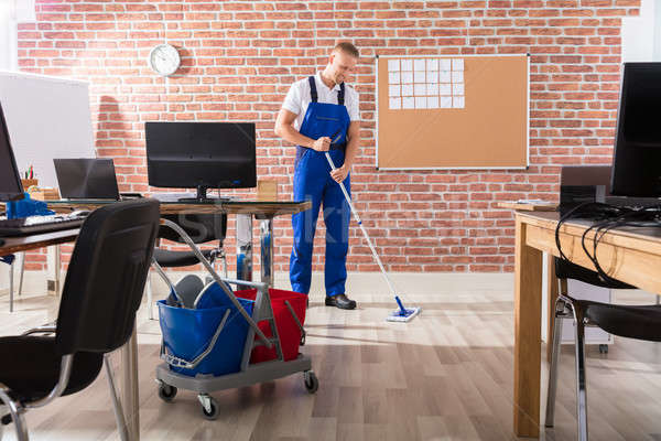 Male Janitor Mopping Floor Stock photo © AndreyPopov