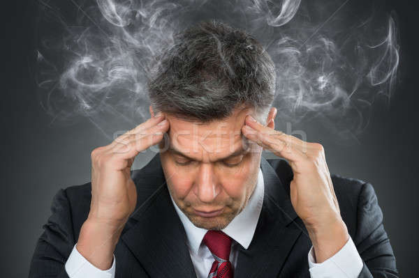 Businessman Suffering From Headache Stock photo © AndreyPopov