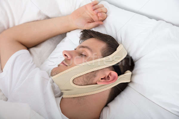 Man Sleeping With Anti Snoring Bandage Stock photo © AndreyPopov