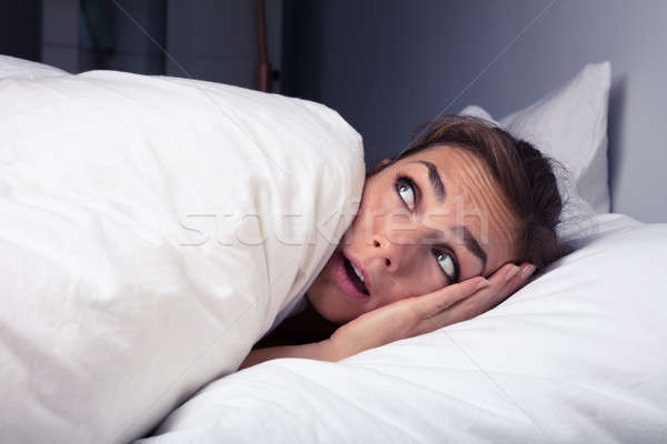 Woman Pulling Bed Sheet Over Self Stock photo © AndreyPopov