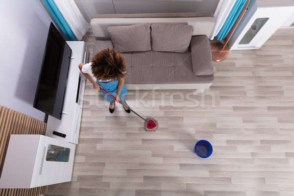 Female Janitor Cleaning Floor With Mop Stock photo © AndreyPopov