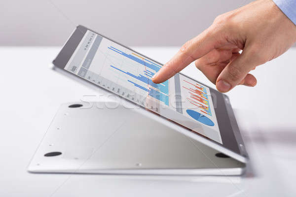 Férfi mutat üzleti grafikon hibrid laptop közelkép Stock fotó © AndreyPopov