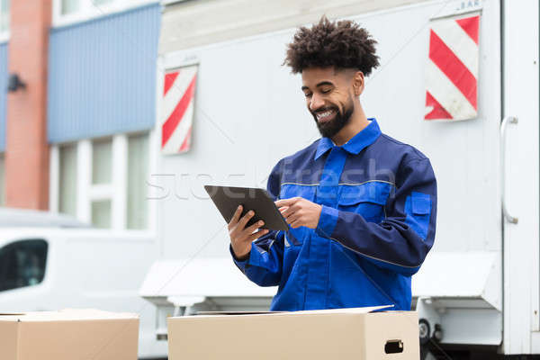 Delivery Man Checking His Order On Digital Tablet Stock photo © AndreyPopov