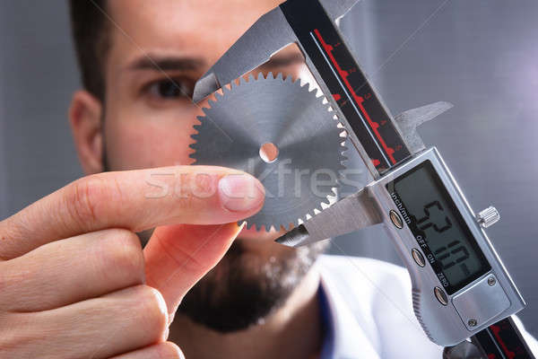 Man Measuring Gear's Size With Digital Caliper Stock photo © AndreyPopov