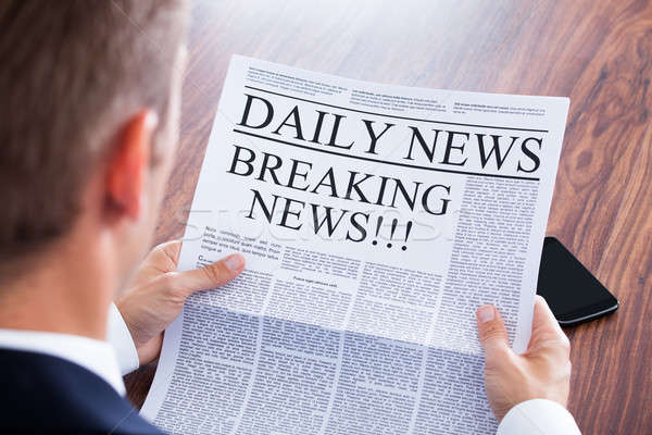 Young Businessman Reading Breaking News Stock photo © AndreyPopov