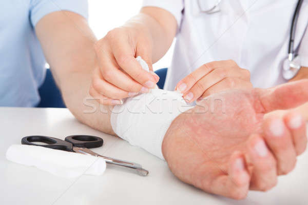 Doctor Bandaging Patient Stock photo © AndreyPopov