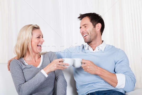 Happy couple enjoying a cup of tea or coffee Stock photo © AndreyPopov