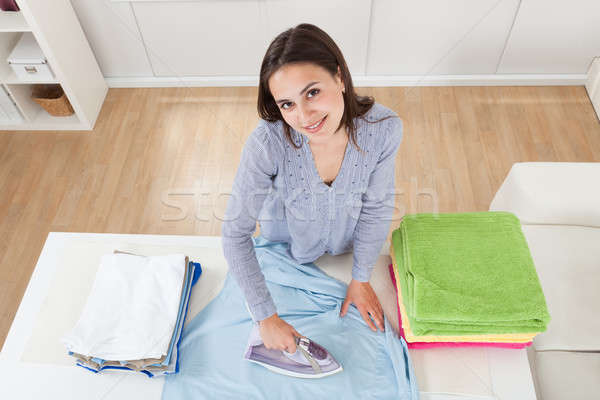 Woman Ironing Clothes In House Stock photo © AndreyPopov