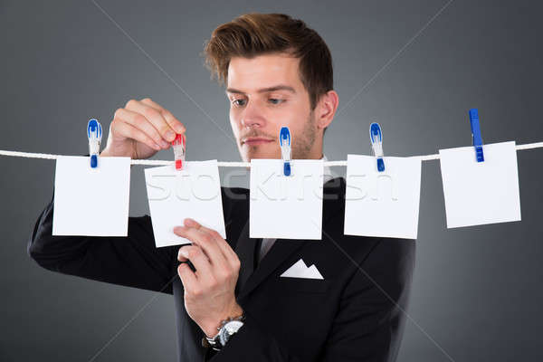 Businessman Pinning Blank Papers On Clothesline Stock photo © AndreyPopov