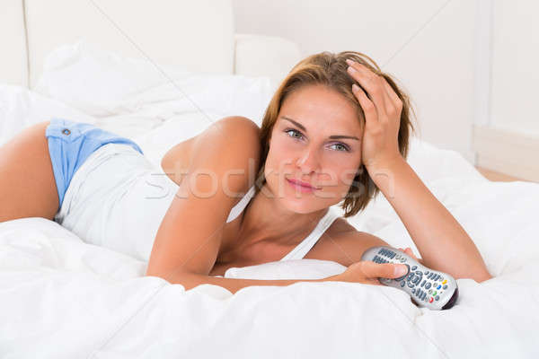 Woman With Tv Remote Control Stock photo © AndreyPopov