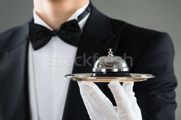 Midsection Of Waiter Holding Service Bell In Plate Stock photo © AndreyPopov
