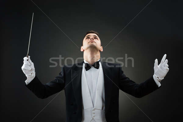 Music Conductor Looking Up While Holding Baton Stock photo © AndreyPopov