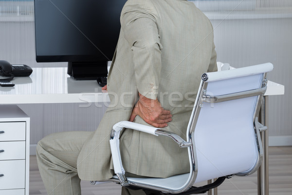 Geschäftsmann Leiden Rückenschmerzen Sitzung Stuhl Büro Stock foto © AndreyPopov